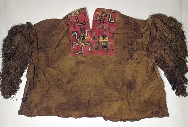 PERU: PARACAS PONCHO. Cotton poncho shirt with neck embroidered with wool yarn, made by the Paracas culture of ancient Peru, 600 B. C. - 175 B. C