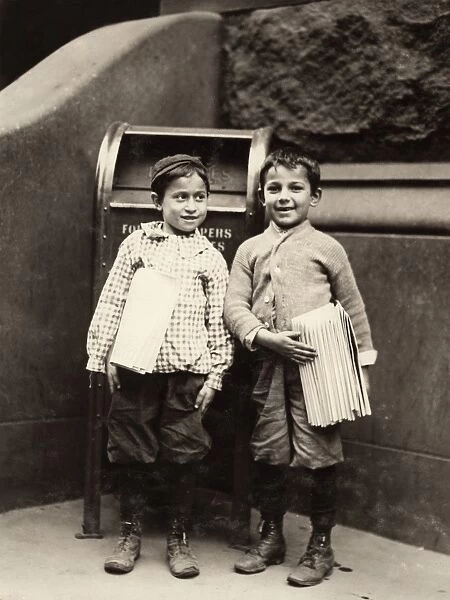 PHILADELPHIA: NEWSBOYS, 1910. Two eight-year-old newsboys selling newspapers in Philadelphia