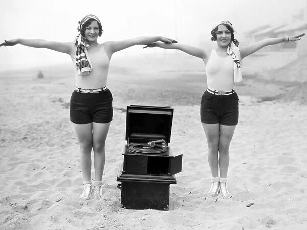 PHONOGRAPH, c1929. Joan Crawford and Dorothy Sebastian photographed c1929 with a portable phonograph in Santa Monica, California