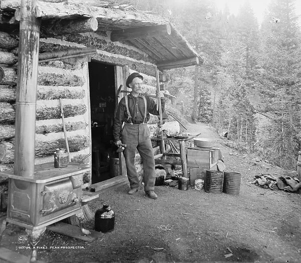 PIKEs PEAK: PROSPECTOR. A prospector stands outside his cabin on Pikes Peak, Colorado