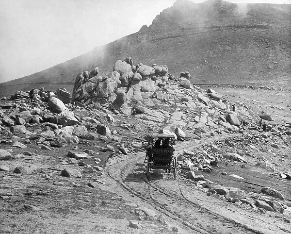 PIKEs PEAK: ROAD, c1890. A carriage bearing the gold rush era motto Pikes Peak