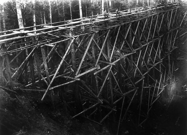 PILE BRIDGE, c1914. Workers constructing a pile bridge which is estimated to be