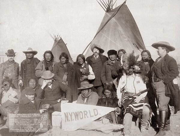 PINE RIDGE RESERVATION. Group portrait of Lakota Sioux chiefs and white U. S. officials, including Buffalo Bill Cody (standing, center), in front of tipis on the Pine Ridge Reservation in South Dakota, with two of the men in front holding a pennant of the New York World newspaper. Photographed by John C. H. Grabill, 16 January 1891