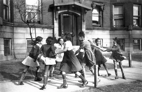 Playing ring around a rosie in the Black Belt neighborhood of Chicago: photograph, April 1941, by Edwin Rosskam