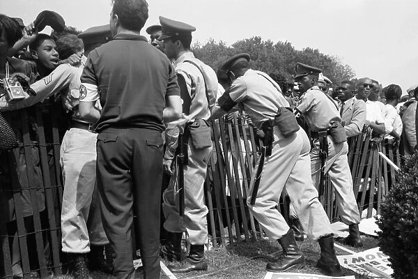 Police attempt to keep Civil Rights demonstrators behind a storm fence at the March on Washington, D. C. Photographed by Marion Trikosko, 28 August 1963