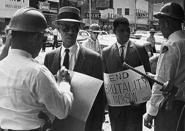 Police officers arrest Medgar Evers and NaCP executive secretary Roy Wilkins, while protesting outside a Woolworths Store in Jackson, Mississippi, 1 June 1963
