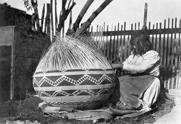 POMO BASKET WEAVER, c1900. A Pomo Native American woman of northwestern California
