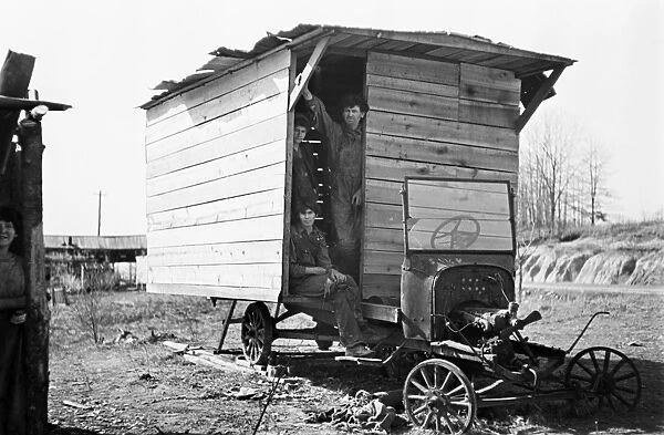 POVERTY: FAMILY, 1936. One-room wooden shelter for a family of eleven, built over
