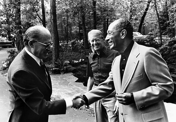 Prime Minister Menachem Begin of Israel (left) shakes hands with President Anwar Sadat of Egypt during their summit meeting in Camp David, Maryland, hosted by U. S. President Jimmy Carter (center), 7 September 1978