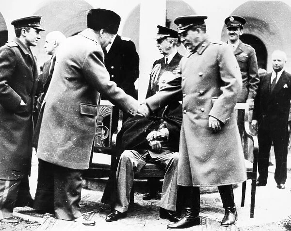 Prime Minister Winston Churchill of Great Britain shakes hands with Soviet Premier Joseph Stalin at the Livadia Palace at the beginning of the Yalta Conference, February 1945. U. S. President Franklin D. Roosevelt is seated at center