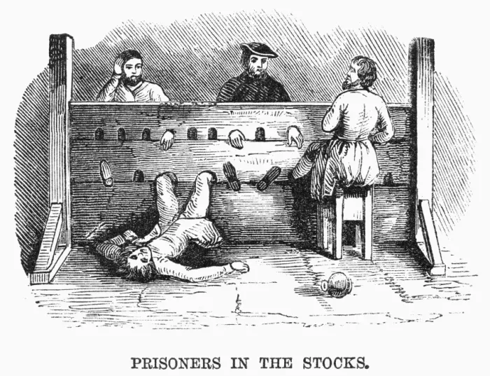PRISONERS IN THE STOCKS. Medieval prisoners in the stocks