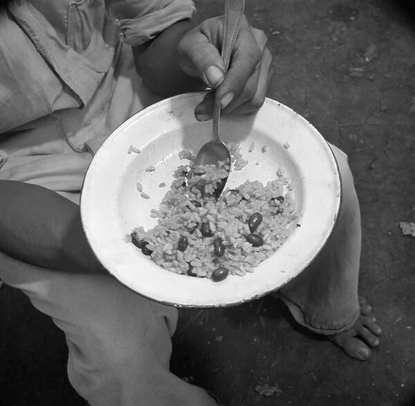 PUERTO RICO: FOOD, 1938. A person eating rice and beans in Puerto Rico