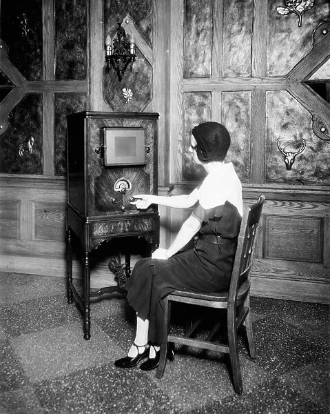 RADIO, c1920. A woman listening to the radio. Photograph, c1920