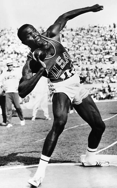 RAFER JOHNSON (1935- ). American decathlon athlete. Johnson competing in the shot put event in the 1960 Summer Olympics in Rome