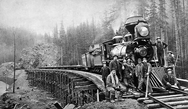 RAILROAD WORKERS, c1880s. American railroad workers, one of them possibly Chinese, posing for the photographer, c1880s, probably in Washington State. No further informaation