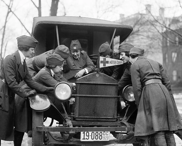 RED CROSS, c1920. Members of the American Red Cross Motor Corps learning to fix an automobile engine, c1920
