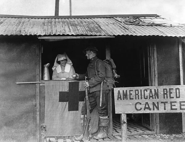 Red Cross worker Mary Webster serves hot chocolate to U. S. Army private Roosevelt in Europe. Photograph, c1918