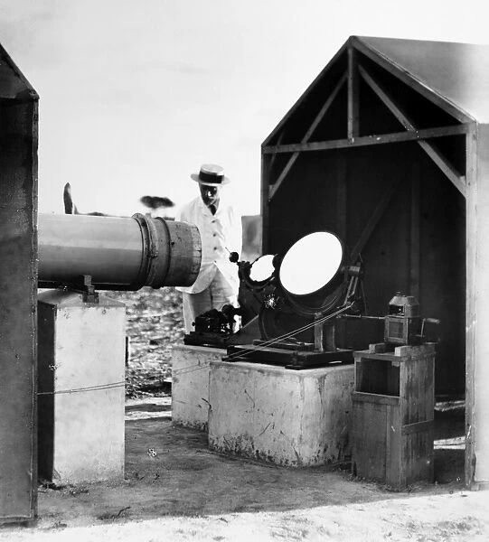 REFLECTING TELESCOPE, c1910. English reflecting telescope at an unidentified tropical location