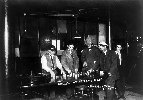RENO: GAMBLING, 1910. Men placing bets on an overland roulette game at a casino in Reno, Nevada