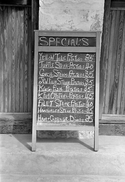 RESTAURANT MENU, 1938. Menu sign for a restaurant in Key West, Florida. Photograph by Arthur Rothstein, 1938