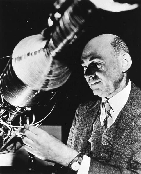 ROBERT HUTCHINGS GODDARD (1882-1945). American physicist. Goddard making adjustments at the upper end of a rocket combustion chamber. Photograph, 1940