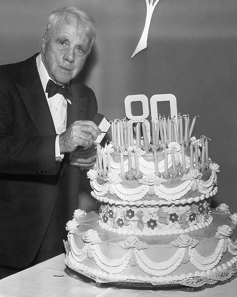 ROBERT LEE FROST (1874-1963). American poet. Preparing to light the candles on the cake at a celebration of his 80th birthday at the Waldorf-Astoria Hotel in New York City, 25 March 1954