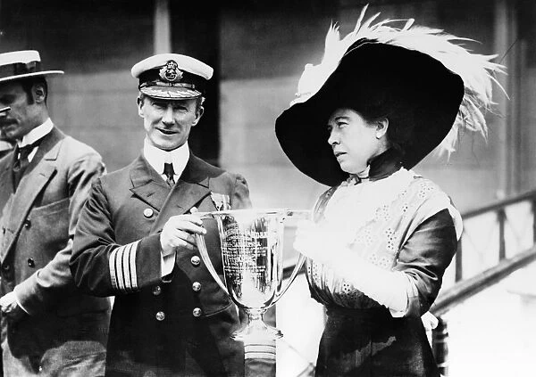 ROSTRON AND BROWN, 1912. Margaret Molly Brown presenting a trophy cup to captain Arthur Henry Rostron of the RMS Carpathia, for rescuing the survivors of the RMS Titanic. Photograph, 29 May 1912