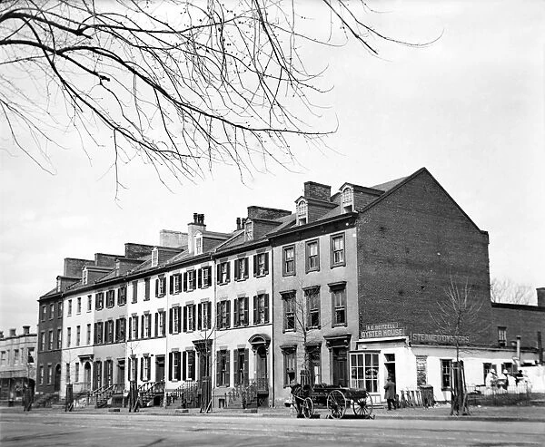 ROW HOUSES, c1919. Row houses identified as farm buildings, with the A