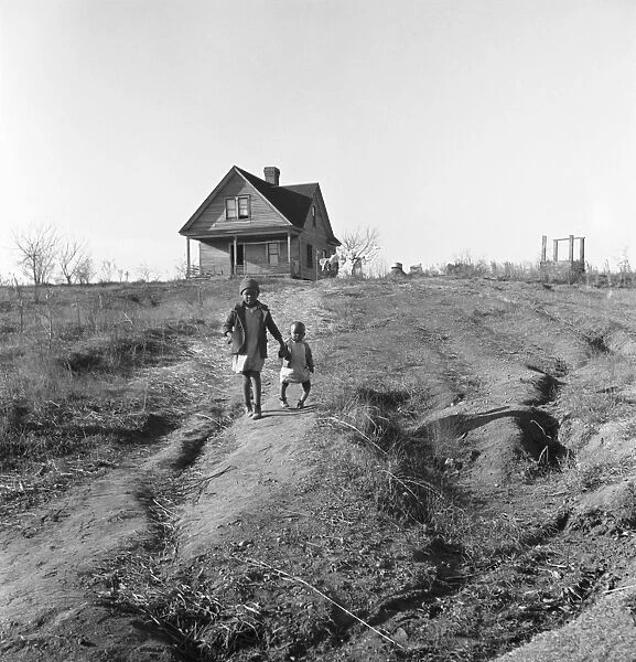 RUN DOWN FARMHOUSE, 1938. Two African American children, one with deformed legs caused by rickets