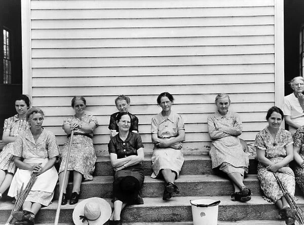 RURAL CHURCH, 1939. Women of the congregation of Wheeleys Church seated on the steps with brooms