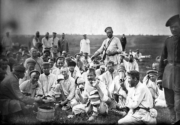 RUSSIA: CONVICTS, c1885. Russian convicts eating lunch by a roadside in Siberia