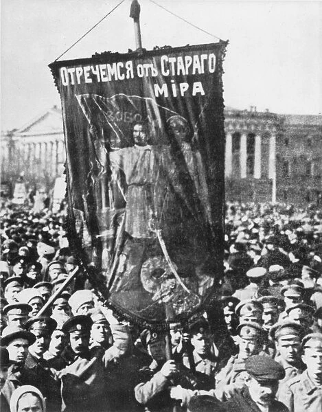 RUSSIA: REVOLUTION OF 1917. A 1917 May Day parade in Petrograds Palace Square, with soldiers hailing the overthrow of tsarism with a banner reading Down With the Old