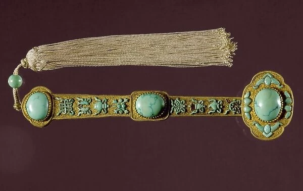 A ruyi scepter and tassel with Buddhist symbols, presented to Emperor Ch ien Lung by a court official in 1783. Gold with turquoise inlay. Ching Dynasty