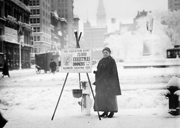 SALVATION ARMY, c1910. Salvation Army volunteer collecting funds for Christmas