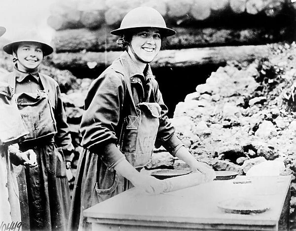 SALVATION ARMY, c1920. Salvation Army at the front. Two women of the Salvation Army baking pies in a trench. Photograph, c1920