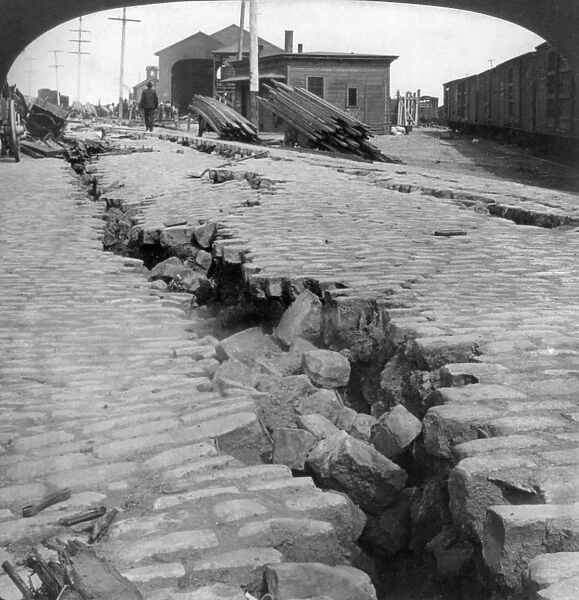 SAN FRANCISCO EARTHQUAKE. A cracked cobblestone street by the waterfront, following the earthquake of 18 April 1906. Stereograph, 1906