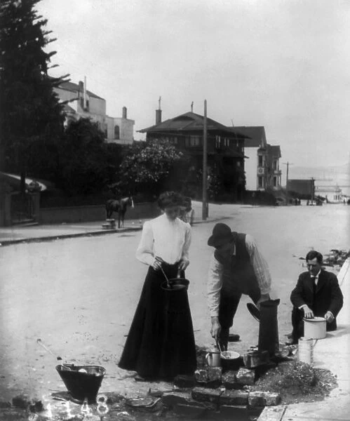 SAN FRANCISCO EARTHQUAKE. A woman and two men cooking on a fire next to the curb
