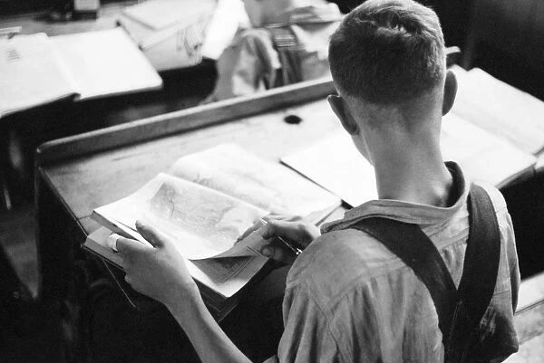 SCHOOLHOUSE, 1939. A boy in a rural schoolhouse in Wisconsin. Photograph by John Vachon