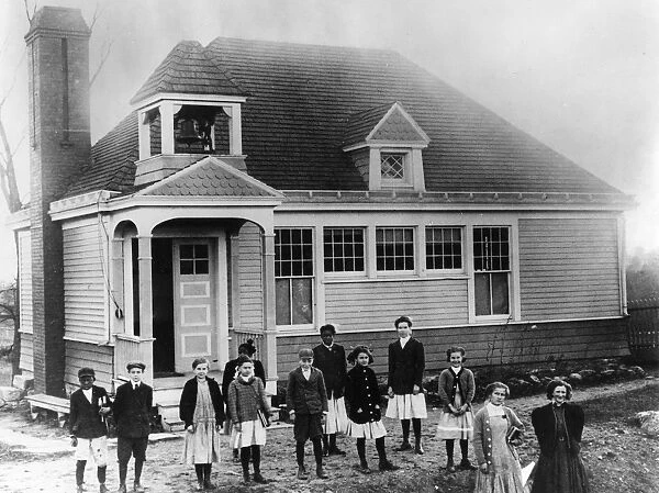 SCHOOLHOUSE, c1910. Black and white children outside of an American schoolhouse