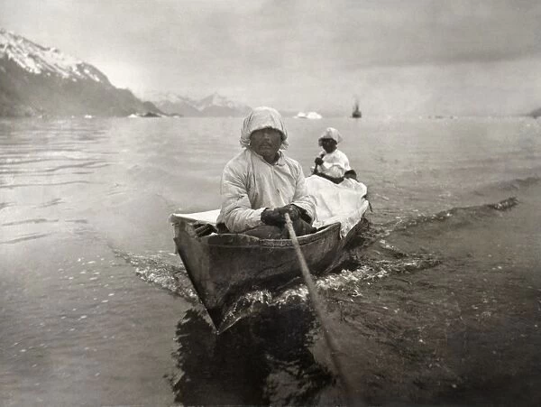 SEAL HUNTERS, c1899. Two Inuit seal hunters in a canoe on the Glacier Bay, Alaska. Photograph by Edward S. Curtis, c1899