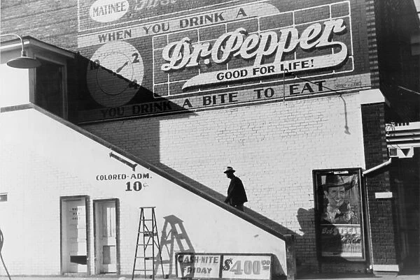 SEGREGATED THEATER, 1939. An African American going into the colored entrance of