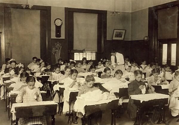 SEWING CLASS, 1909. Working girls learning sewing at the Vocational Hancock School in Boston