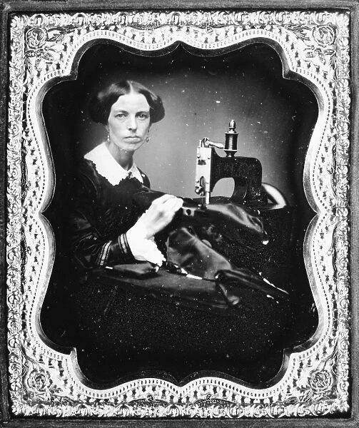 SEWING MACHINE, c1853. Seamstress with an 1853 model Grover and Baker industrial sewing machine