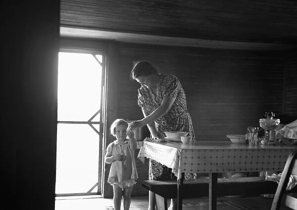 SHARECROPPER, 1939. The wife and child of a tobacco sharecropper inside their farm