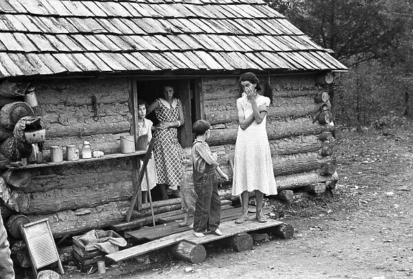 SHARECROPPER FAMILY, 1935. A family of a sharecropper standing in front of their farmhouse