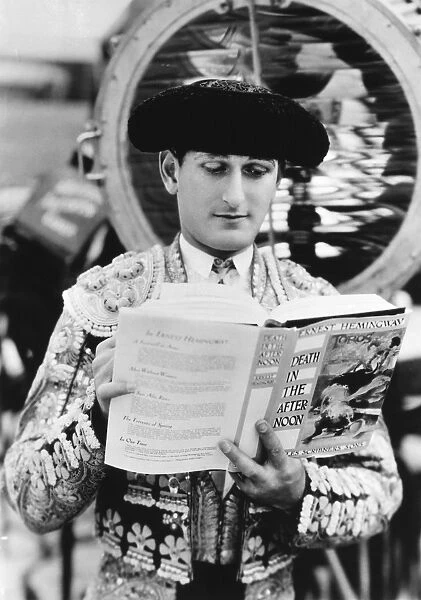 SIDNEY FRANKLIN (1903-1976). American bullfighter. Photographed while reading from Ernest Hemingways Death in the Afternoon, mid-20th century