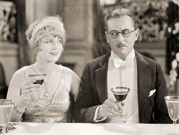 SILENT FILM STILL: DRINKING. Helen Lynch and Matt Moore in a still from Three Weeks in Paris, 1925