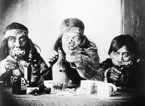 SILENT FILM STILL. Native Americans hold Douglas Fairbanks at bay