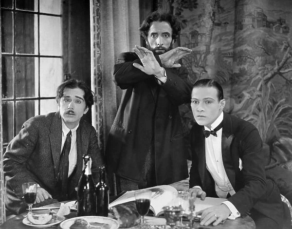 SILENT STILL: GROUP OF MEN. Rudolph Valentino in a still from the film The Four Horseman of the Apocalypse (Metro, 1921)