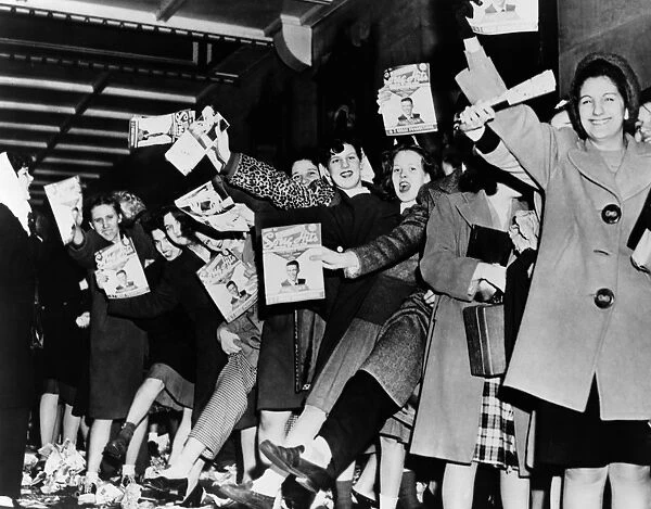 SINATRA FANS, 1945. A crowd of teenage girls with copies of Song Hits magazine